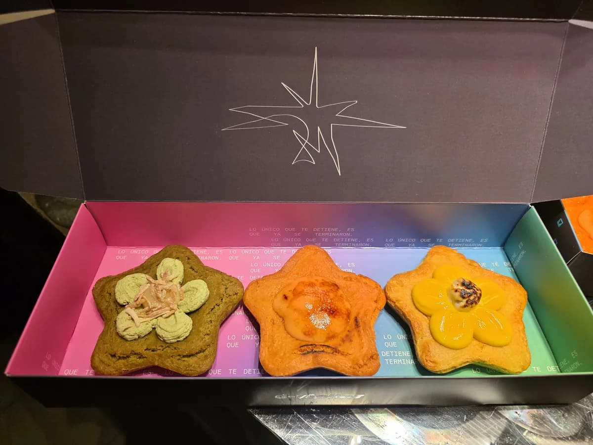 Three flower-shaped cookies from March's collection in their box